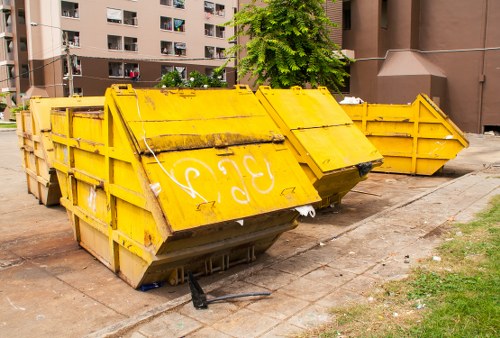Construction site with waste removal trucks in Hounslow